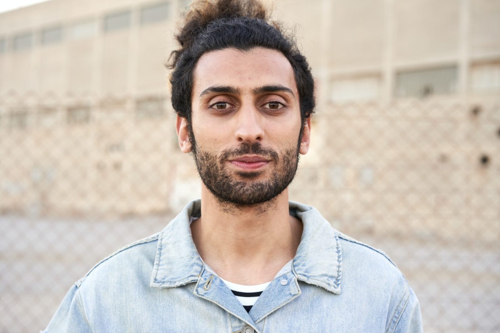 Portrait of a serious muslim young man looking at camera.